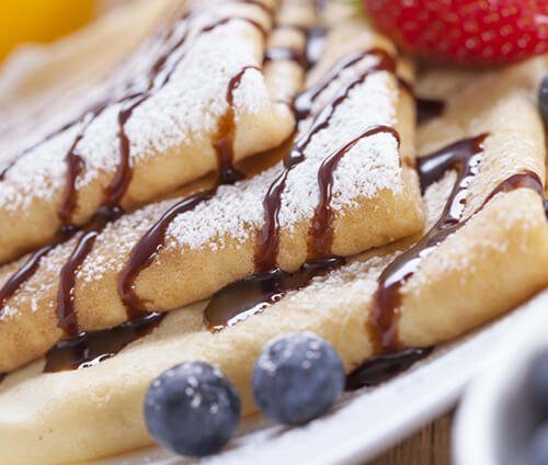 Sweet crepes with chocolate drizzle and powdered sugar — Crepes of Paris French breakfast catering in Los Angeles